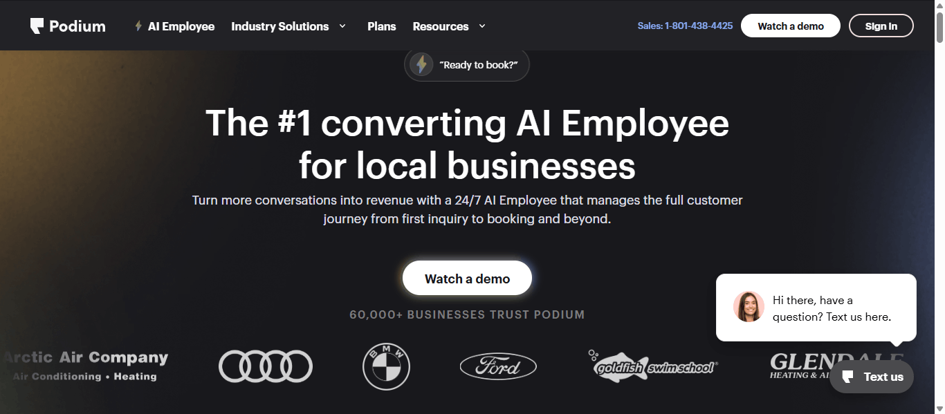 Podium homepage showing The #1 converting AI Employee for local businesses headline, a Watch a demo button, 60,000+ businesses trust Podium logos, and a Text us chat widget.